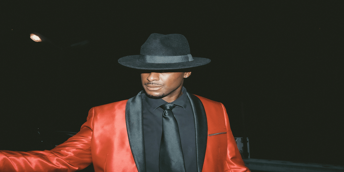 Image commercially licensed from https://unsplash.com/photos/man-in-black-hat-and-red-blazer-AmORQArz3Ds