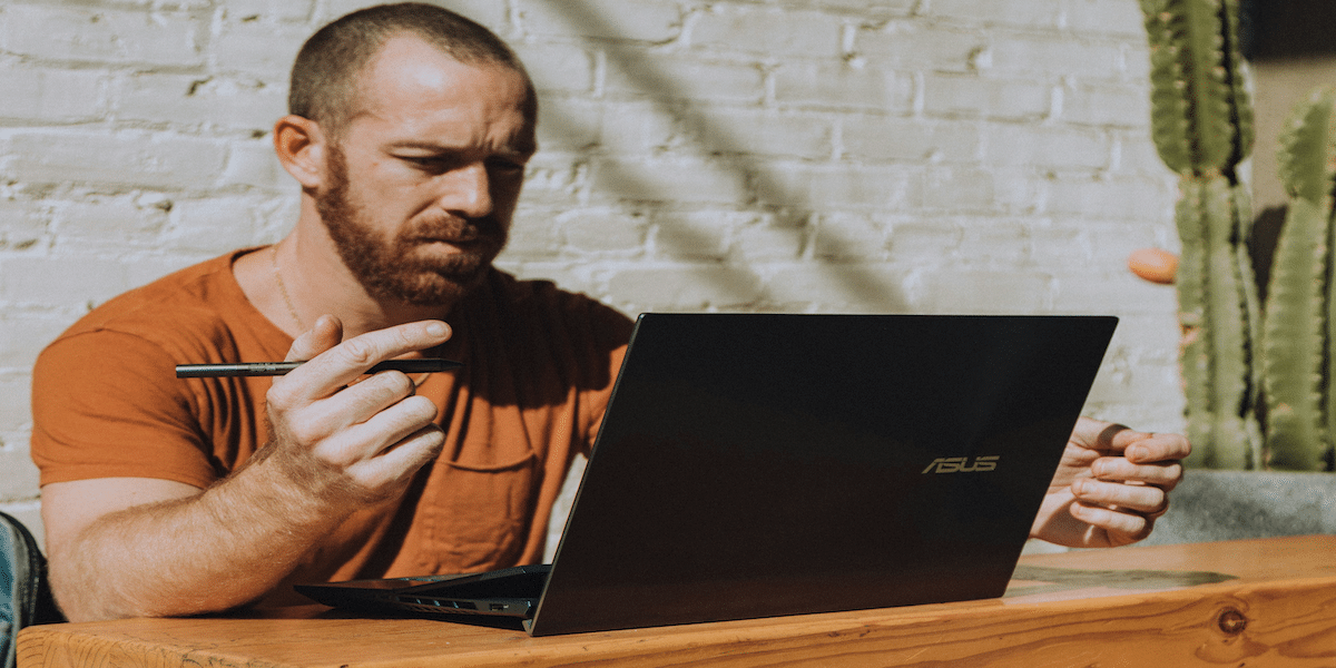 Image commercially licensed from https://unsplash.com/photos/a-man-sitting-at-a-table-using-a-laptop-computer-QhYwsqiuj9g