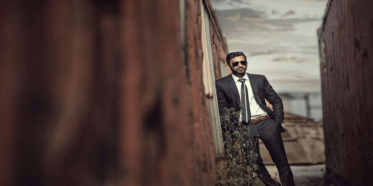 Image commercially licensed from https://unsplash.com/photos/man-in-black-suit-standing-on-brown-wooden-bridge-during-daytime-LxoWI68KRnA