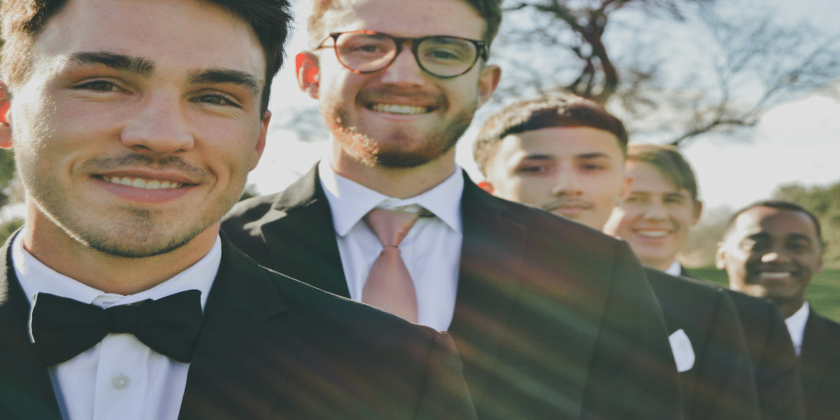 Image commercially licensed from https://unsplash.com/photos/a-group-of-men-in-tuxedos-standing-next-to-each-other-iKEODGbS0Hc