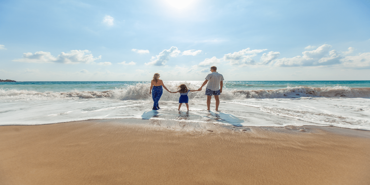 Image commercially licensed from https://unsplash.com/photos/man-woman-and-child-holding-hands-on-seashore-SIOdjcYotms